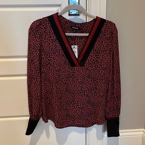 Express blouse never been worn. Rust leopard print with black and rust trim